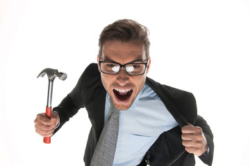 Angry businessman about to hammer on white background.