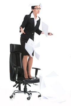 angry businesswoman shouting when standing on chair.