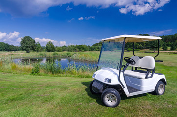 Golf car near the water pond