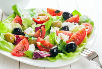 Plate of fresh salad with feta and olives