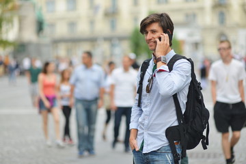 Student with the mobile smart phone walking