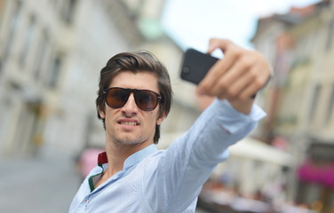 Young fashionable hipster Hispanic man  taking a selfie