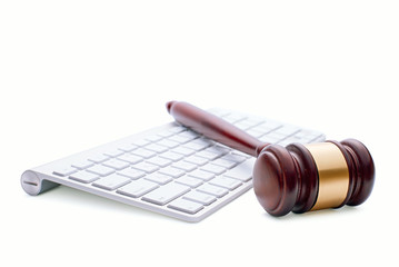 Wooden gavel on a white computer keyboard
