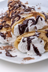 Pancakes with whipped cream topped with chocolate