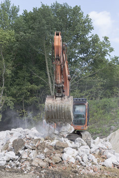 Working excavator during the removal of stones