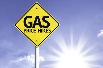 Naklejka premium Gas Price Hikes road sign with sun background