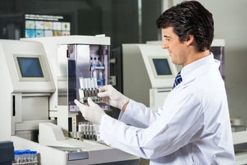 Naklejka na ściany i meble Scientist Analyzing Urine Samples In Laboratory