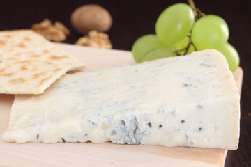 Gorgonzola blue cheese on wooden chopping board