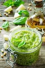 fresh pesto sauce on a dark wood background
