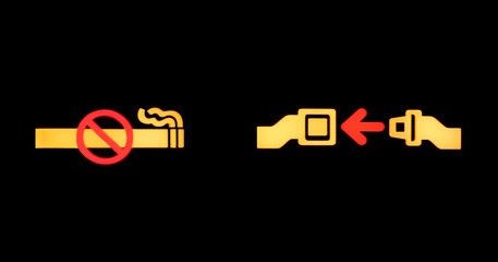 Airplane seatbelt sign and non smoking sign isolated on black