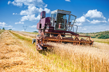 old combine corn and wheat harvester. Agriculture industry