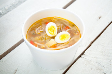 chicken soup with noodles and boiled eggs