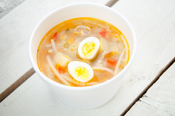 chicken soup with noodles and boiled eggs