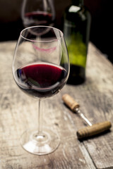 Wine glass with lipstick mark and bottle