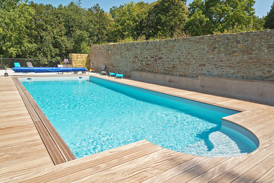 Summer Outdoor Swimming Pool With Green Trees.