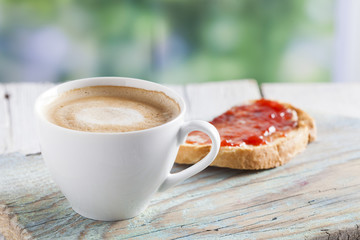 Coffee cup on a wooden table outdoors