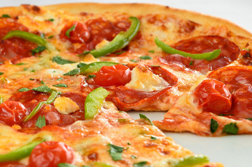 Pepperoni pizza with green peppers and sundried tomatoes