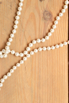 pearl necklace on wood