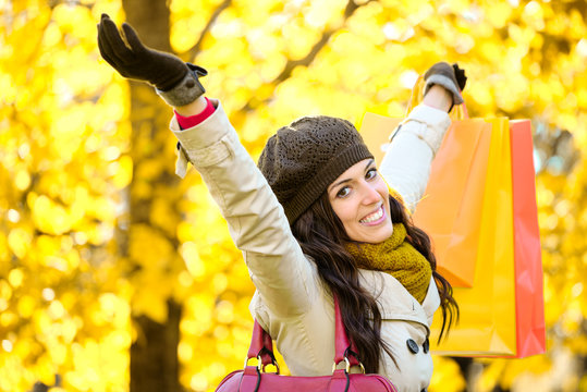 Joyful woman shopping and having fun in autumn