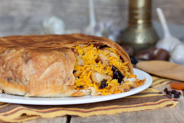 Pilaf in tortillas with dried fruits, garlic and burberry
