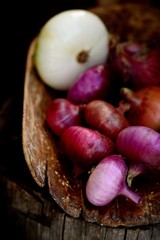 Fresh red onions on a wooden background