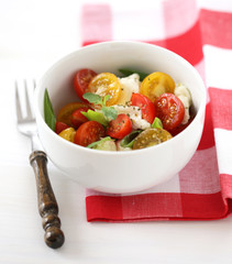 Caprese with red and yellow cherry tomatoes