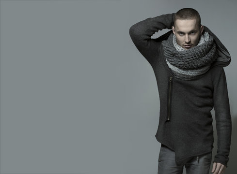 Young handsome man in a grey wrap, shawl