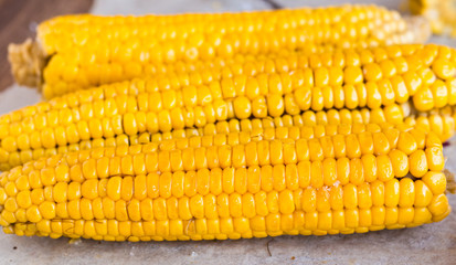 hot yellow corn on the wooden background