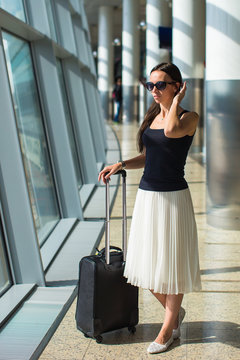 Young beautiful woman in airport while waiting for flight