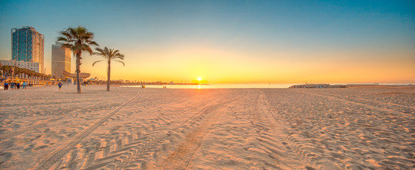 Fototapeta premium Barceloneta Beach in Barcelona at sunrise