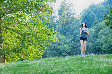 Female athlete and runner running on park