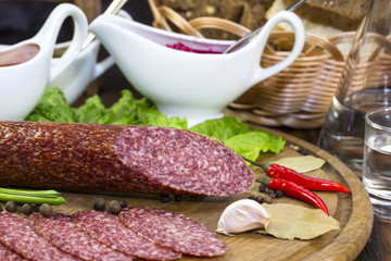 sausages on a wooden plate with vegetables in a restaurant