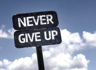 Never Give Up sign with clouds and sky background