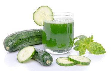 Composition with a glass of cucumber juice and fresh cucumbers