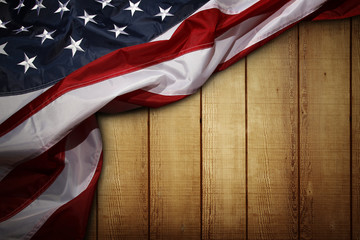 American flag on brown wooden boards wall background. Copy space