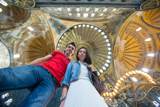 Young couple tourists inside the Blue Mosque on a background of