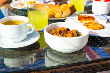 Delicious breakfast with flakes,dried fruit and cup of tea