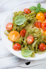 Close-up of boiled tagliatelle with fried tomatoes, studio shot