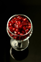 pomegranate seeds on black
