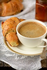 Poppy seed croissant with a cup of coffee