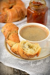 Poppy seed croissant with a cup of coffee