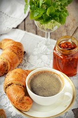 Poppy seed croissant with a cup of coffee