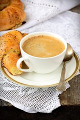 Poppy seed croissant with a cup of coffee