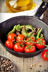 Cherry tomatoes cooking in pan