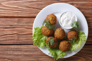 falafel with sauce tzatziki close-up view from above