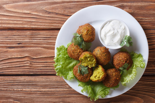 delicious falafel on lettuce with tzatziki top view