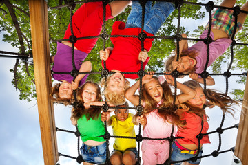 Many kids look though gridlines of playground