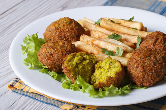 falafel with French fries on a white plate closeup horizontal