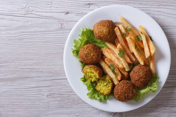falafel with French fries, lettuce top view horizontal