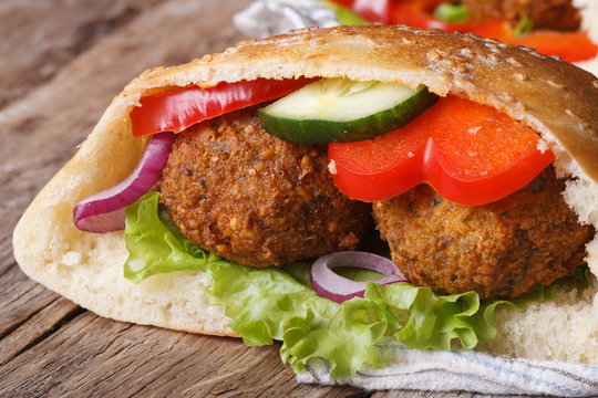 falafel with fresh vegetables in pita bread close-up